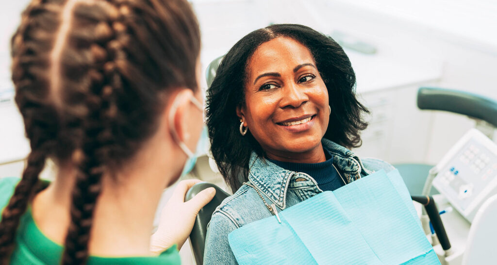 Junge Frau lächelt mit perfekten Zähnen nach Bleaching beim Zahnarzt Laupheim.